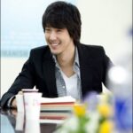 Smiling young man at meeting table