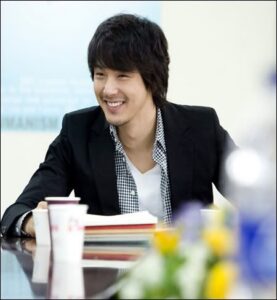 Smiling young man at meeting table
