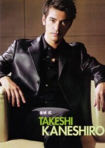 Man in black leather jacket seated in armchair