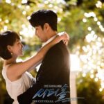 Couple embracing beneath twinkling lights