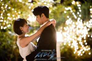 Couple embracing beneath twinkling lights