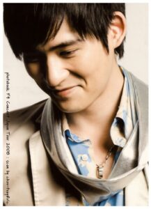 Smiling young man wearing scarf and necklace