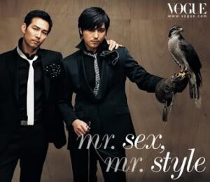 Two men in suits, one holding a falcon