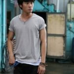 Young man standing in industrial alleyway