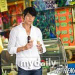 Man holding two ice cream cones in shop