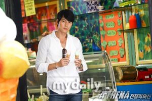 Man holding two ice cream cones in shop