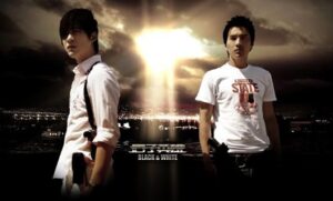 Two men with dramatic sky and city lights