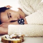 Man lying with watch and cigarette ashtray