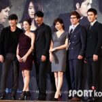 Group of formally dressed people posing at event