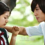 Male student leaning toward female student