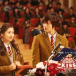 Two students in school uniforms at podium