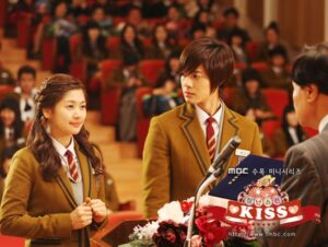 Two students in school uniforms at podium