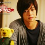 Young man looking at teddy bear