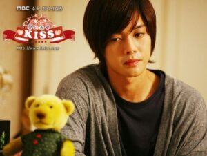 Young man looking at teddy bear