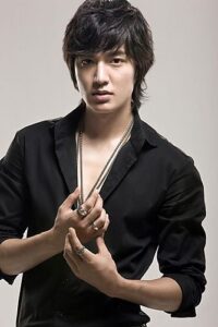 Young man in black shirt posing with necklaces