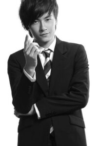 Young man in suit pointing at camera