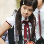 Schoolgirl in uniform pouting with backpack