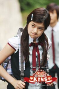 Schoolgirl in uniform pouting with backpack