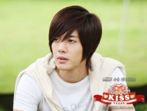 Young man with layered brown hair outdoors