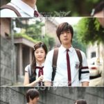 Two students in school uniforms walking