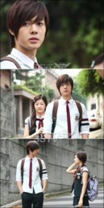 Two students in school uniforms walking