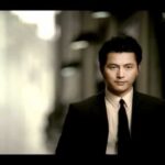 Man in suit walking down hallway