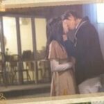 Couple kissing inside ornate framed photograph