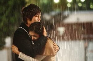Romantic couple embracing in pouring rain