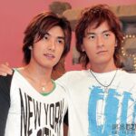 Two young men posing arm in arm