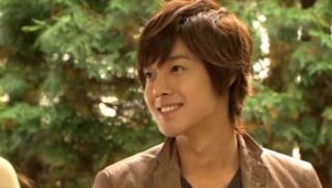 Smiling young man outdoors with trees background