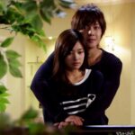Young couple embracing tenderly on indoor balcony
