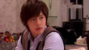 Young man sitting at table wearing vest