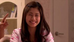 Smiling young woman in pink pajamas