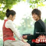 Smiling young couple exchanging gift outdoors