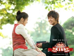 Smiling young couple exchanging gift outdoors
