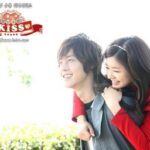 Young couple smiling, woman on man's back