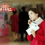 Young woman in red coat holding papers