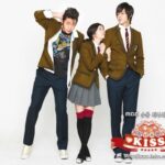 Three students in school uniforms posing together