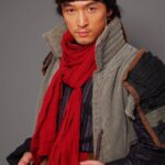 Man in historical costume with red scarf