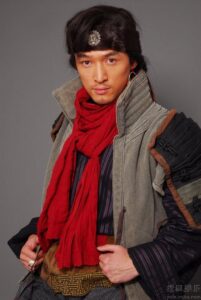 Man in historical costume with red scarf