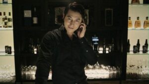 Man talking on phone at dimly lit bar