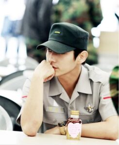 Soldier in uniform with heart-sticker bottle
