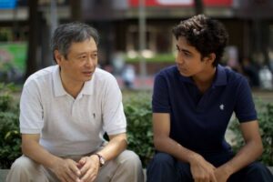 Two men sitting and talking outdoors