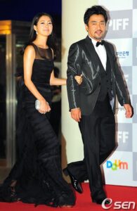 Couple in black formalwear on red carpet