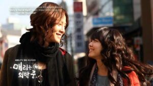 Two smiling women walking on sunny city street