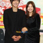 Smiling young couple holding hands
