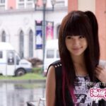 Smiling woman with long dark hair outdoors