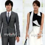 Two formally dressed people posing together
