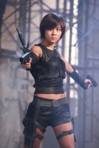Woman in black tactical outfit aiming pistols