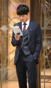 Man in navy suit reading brochure
